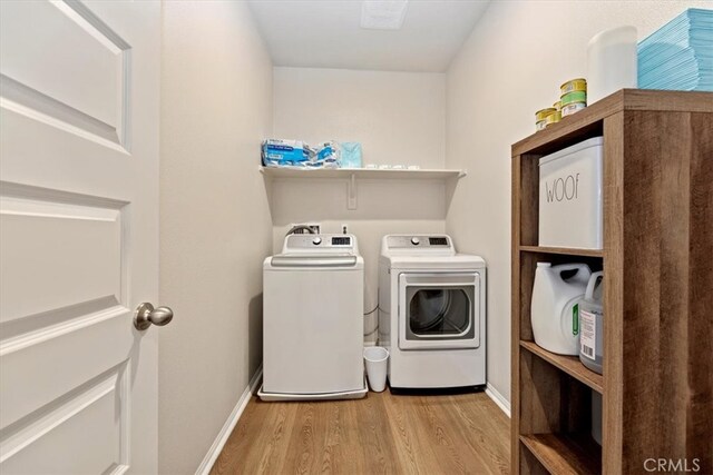 11653 Couples Ct, Beaumont, CA 92223 - laundry room featuring separate washer and dryer, wood finished floors, and baseboards