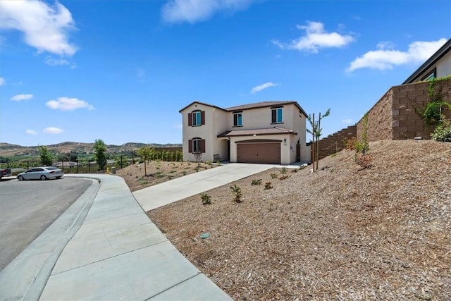 11653 Couples Ct, Beaumont, CA 92223 - view of front of home featuring an attached garage, stucco siding, driveway, a tiled roof, and a mountain view