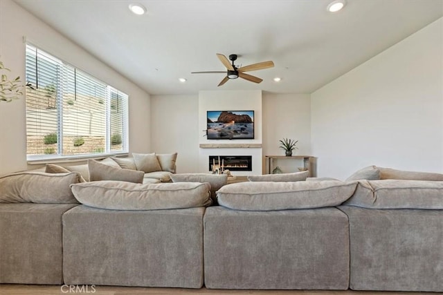 11653 Couples Ct, Beaumont, CA 92223 - living area with healthy amount of natural light, ceiling fan, recessed lighting, and a glass covered fireplace