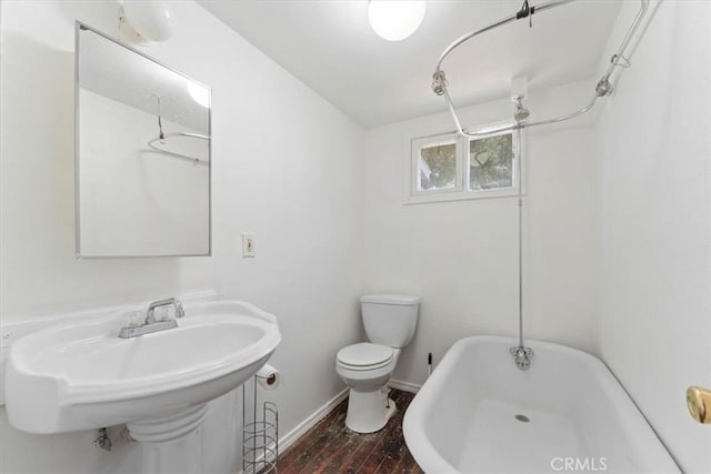 818 6th St, Corning, CA 96021 - bathroom featuring toilet, wood finished floors, baseboards, and tub / shower combination