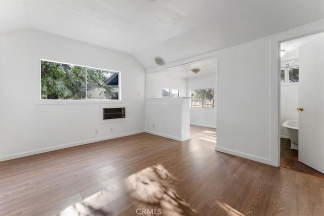 818 6th St, Corning, CA 96021 - unfurnished living room featuring lofted ceiling, wood finished floors, and baseboards