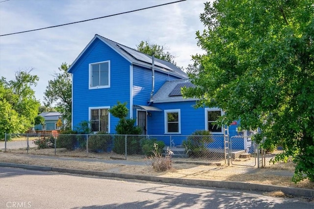 818 6th St, Corning, CA 96021 - view of front of property featuring roof mounted solar panels and a fenced front yard