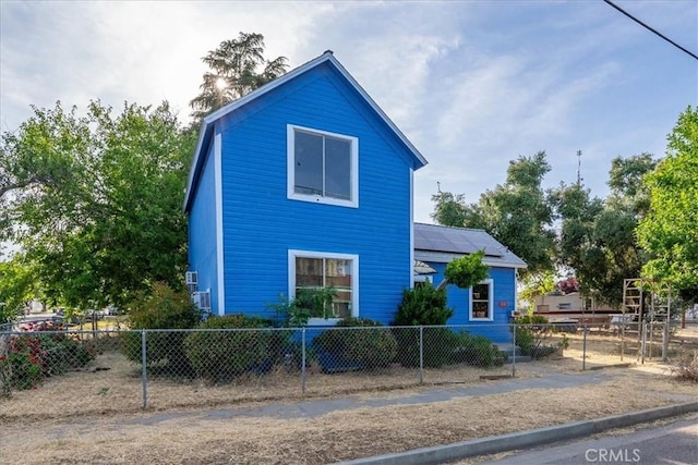818 6th St, Corning, CA 96021 - view of side of property featuring a fenced front yard and roof mounted solar panels