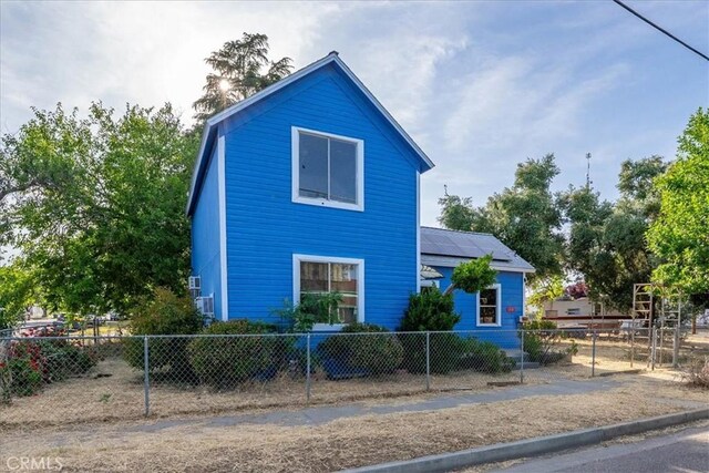 818 6th St, Corning, CA 96021 - view of property exterior featuring a fenced front yard and solar panels
