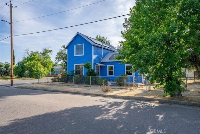 818 6th St, Corning, CA 96021 - view of front of house with solar panels and a fenced front yard