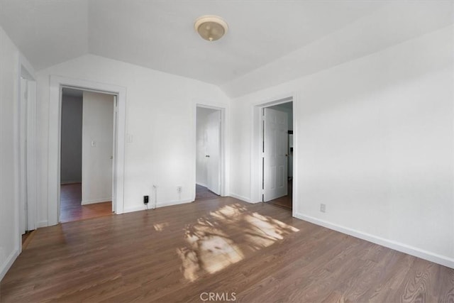 818 6th St, Corning, CA 96021 - unfurnished bedroom featuring vaulted ceiling, wood finished floors, and baseboards