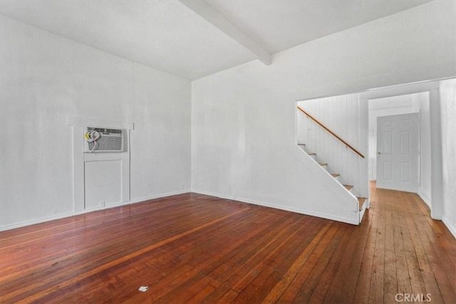818 6th St, Corning, CA 96021 - spare room featuring stairs, wood-type flooring, a wall unit AC, beam ceiling, and baseboards