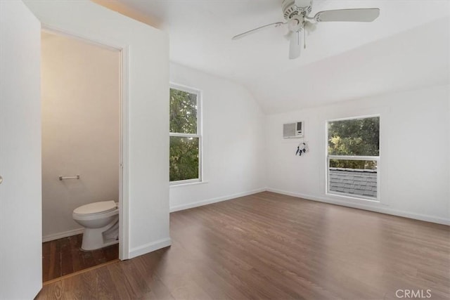 818 6th St, Corning, CA 96021 - unfurnished living room featuring lofted ceiling, wood finished floors, ceiling fan, and a wall unit AC