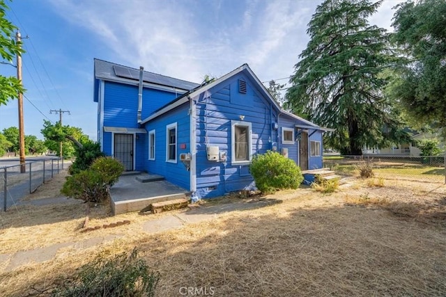 818 6th St, Corning, CA 96021 - back of property with solar panels and a fenced backyard
