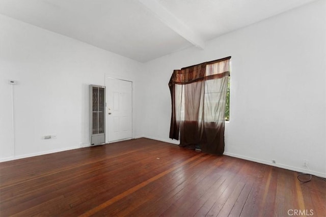818 6th St, Corning, CA 96021 - spare room featuring wood-type flooring, beam ceiling, and baseboards