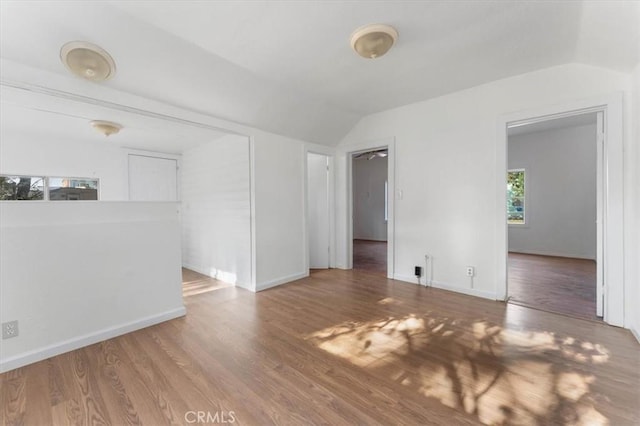 818 6th St, Corning, CA 96021 - unfurnished living room featuring vaulted ceiling, wood finished floors, and baseboards