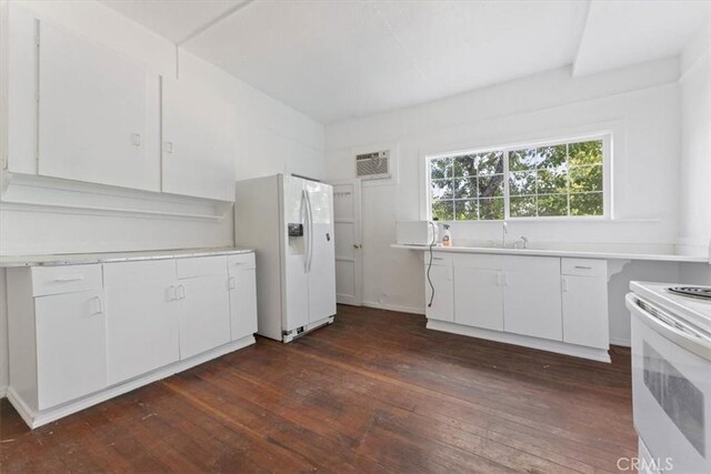 818 6th St, Corning, CA 96021 - kitchen with white appliances, white cabinets, light countertops, and dark wood-type flooring