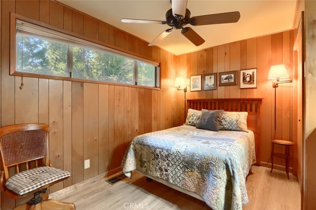 8067 Chilnualna Falls Rd, Wawona, CA 95389 - bedroom featuring wood finished floors, wood walls, and a ceiling fan