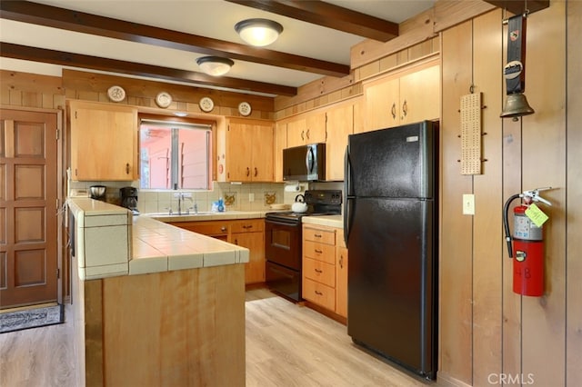 8067 Chilnualna Falls Rd, Wawona, CA 95389 - kitchen with black appliances, tile countertops, beam ceiling, tasteful backsplash, and light wood-style flooring