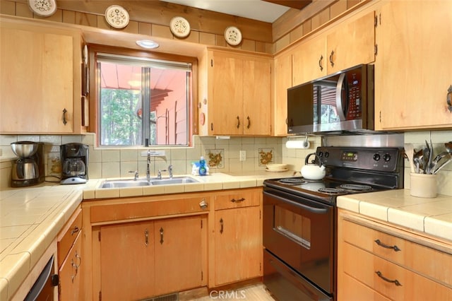 8067 Chilnualna Falls Rd, Wawona, CA 95389 - kitchen featuring black range with electric stovetop, stainless steel microwave, a sink, and tasteful backsplash