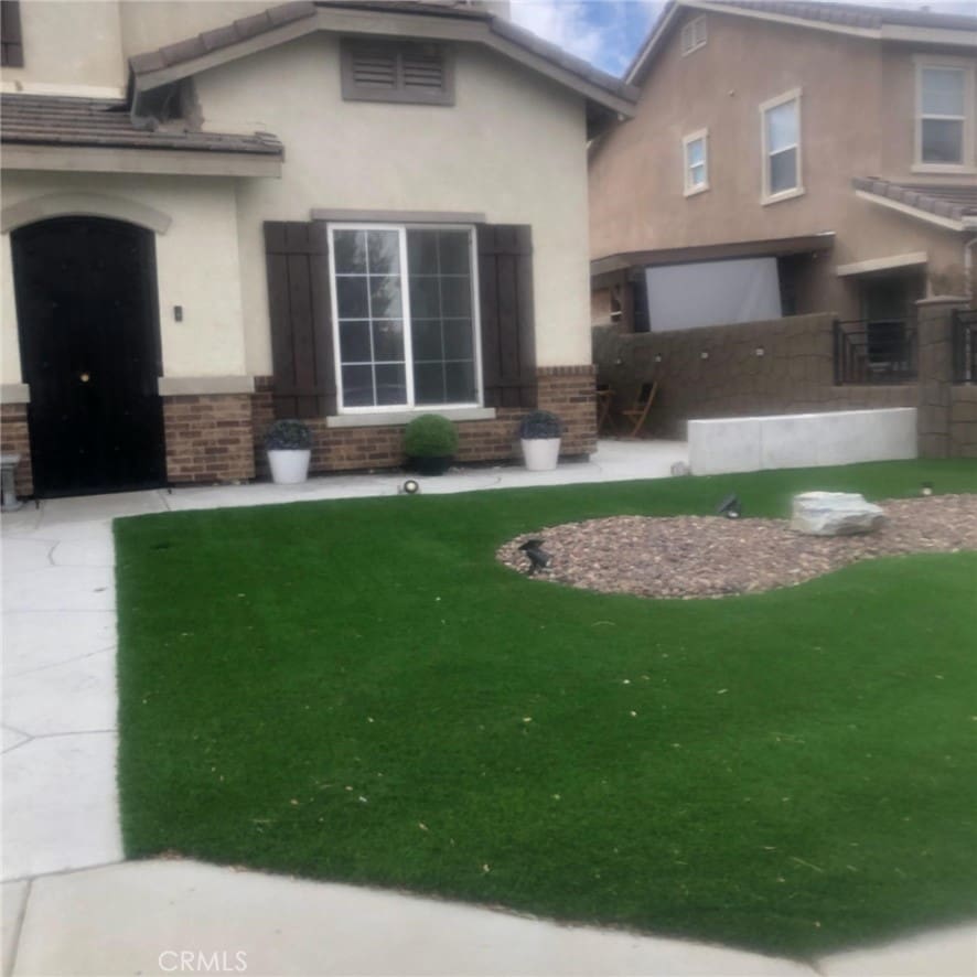 3042 San Luis Dr, Lancaster, CA 93535 - back of house with stucco siding and brick siding