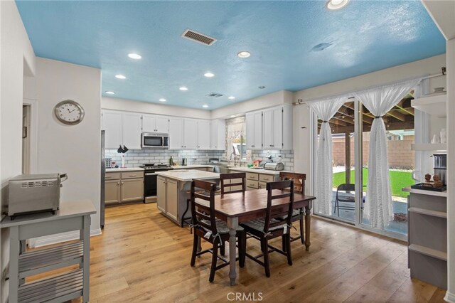 3042 San Luis Dr, Lancaster, CA 93535 - dining area with light wood-type flooring and recessed lighting