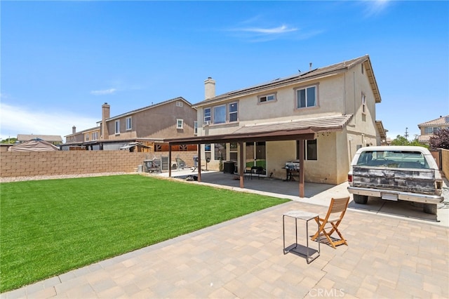 3042 San Luis Dr, Lancaster, CA 93535 - back of house with stucco siding and a patio area