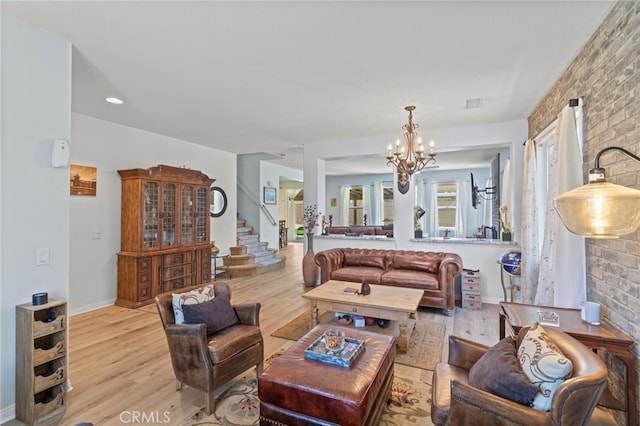 3042 San Luis Dr, Lancaster, CA 93535 - living room with wood finished floors, a chandelier, and stairs