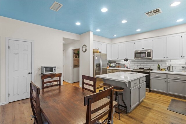 3042 San Luis Dr, Lancaster, CA 93535 - kitchen featuring appliances with stainless steel finishes, gray cabinets, light countertops, decorative backsplash, and recessed lighting