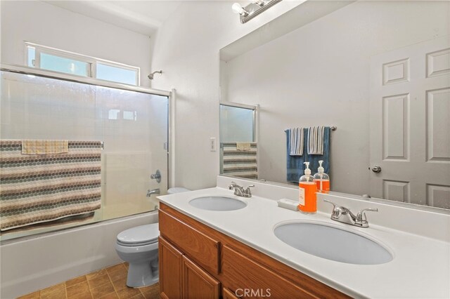 3042 San Luis Dr, Lancaster, CA 93535 - full bathroom with toilet, combined bath / shower with glass door, and double vanity