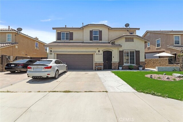3042 San Luis Dr, Lancaster, CA 93535 - traditional-style house with stucco siding, driveway, a garage, and brick siding
