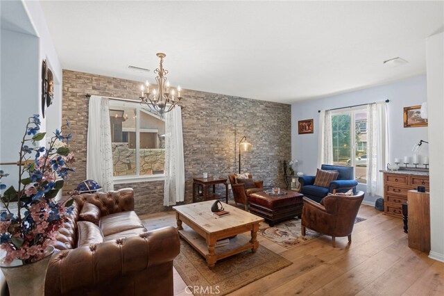 3042 San Luis Dr, Lancaster, CA 93535 - living room featuring light wood finished floors and a chandelier