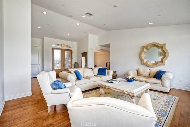 1177 Estee Ct, Fallbrook, CA 92028 - living room with arched walkways, french doors, vaulted ceiling, wood finished floors, and baseboards