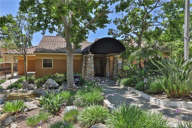 10655 Lemon Ave Unit 2402, Rancho Cucamonga, CA 91737 - view of front of house featuring a tiled roof, stucco siding, and stone siding