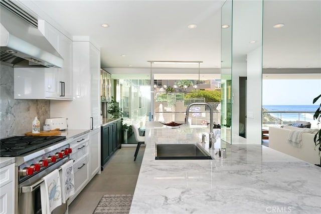 1585 S Coast Unit 2, Laguna Beach, CA 92651 - kitchen featuring high end stainless steel range, ventilation hood, a sink, white cabinets, and recessed lighting
