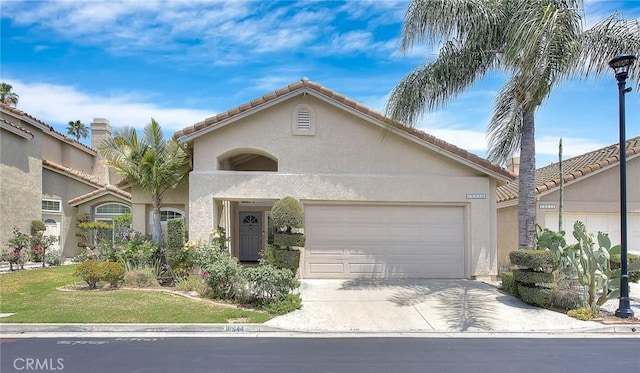 10644 Claridge Pl, Whittier, CA 90603 - mediterranean / spanish house featuring stucco siding, concrete driveway, a garage, and a tile roof