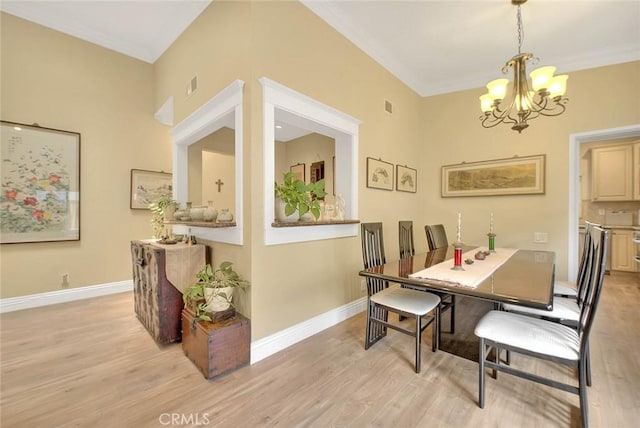 10644 Claridge Pl, Whittier, CA 90603 - dining area featuring light wood finished floors, a chandelier, baseboards, and ornamental molding
