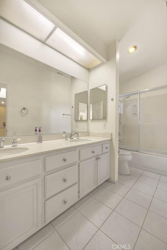 10644 Claridge Pl, Whittier, CA 90603 - bathroom with tile patterned flooring, double vanity, shower / bath combination with glass door, toilet, and recessed lighting