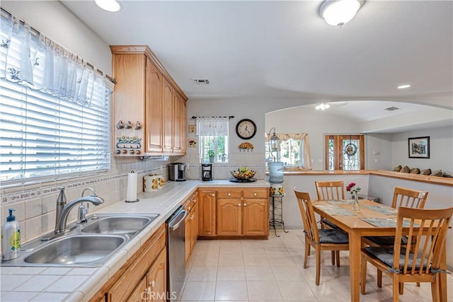 8960 Telfair Ave, Sun Valley, CA 91352 - kitchen with tile counters, stainless steel dishwasher, arched walkways, decorative backsplash, and recessed lighting