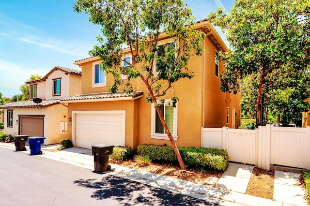 5764 Alcala Way, Riverside, CA 92505 - view of property with an attached garage, stucco siding, driveway, and a tile roof