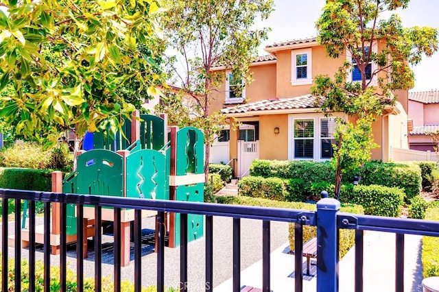 5764 Alcala Way, Riverside, CA 92505 - mediterranean / spanish-style home featuring a tiled roof, a playground, and stucco siding