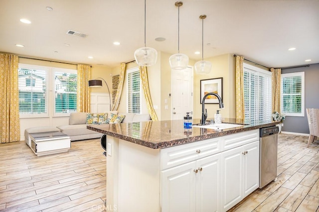 5764 Alcala Way, Riverside, CA 92505 - kitchen with a sink, light wood finished floors, an island with sink, stainless steel dishwasher, and dark stone counters