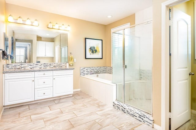5764 Alcala Way, Riverside, CA 92505 - full bathroom with healthy amount of natural light, a garden tub, double vanity, and a stall shower