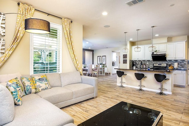 5764 Alcala Way, Riverside, CA 92505 - living area featuring recessed lighting and light wood-style flooring