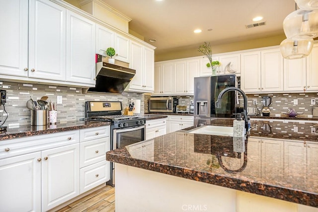5764 Alcala Way, Riverside, CA 92505 - kitchen with appliances with stainless steel finishes, a sink, backsplash, white cabinets, and under cabinet range hood
