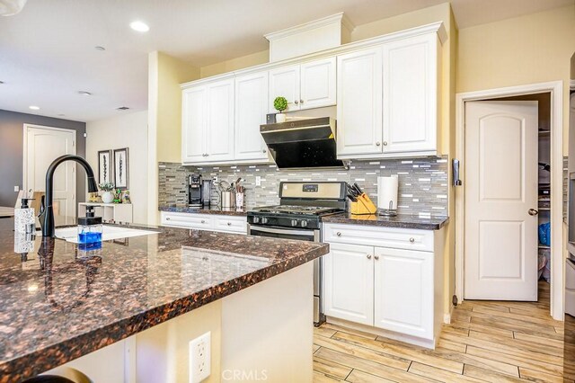 5764 Alcala Way, Riverside, CA 92505 - kitchen with stainless steel gas stove, decorative backsplash, white cabinetry, and recessed lighting