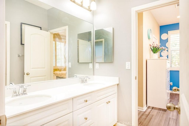 5764 Alcala Way, Riverside, CA 92505 - ensuite bathroom featuring double vanity, wood finished floors, and baseboards