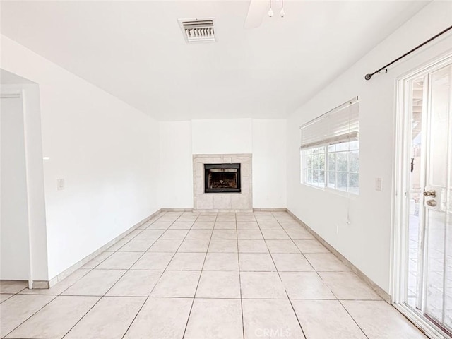 37627 Citrus Dr, Palmdale, CA 93550 - unfurnished living room featuring a tiled fireplace and light tile patterned flooring