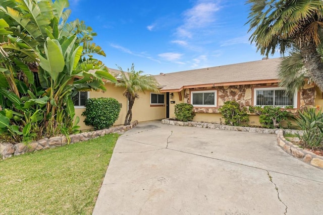 2862 Coronado Ave, San Diego, CA 92154 - view of front facade featuring stucco siding, a front yard, and stone siding