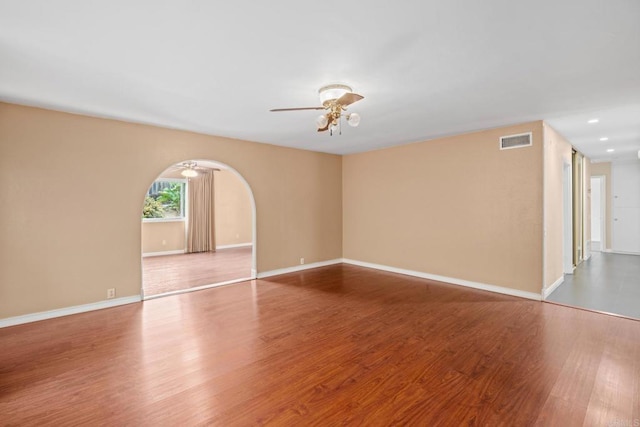 2862 Coronado Ave, San Diego, CA 92154 - spare room with arched walkways, a ceiling fan, wood finished floors, baseboards, and recessed lighting
