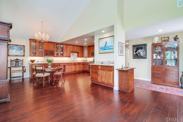 1129 La Casa, San Marcos, CA 92078 - kitchen featuring dark wood-style floors, light countertops, a chandelier, brown cabinets, and high vaulted ceiling