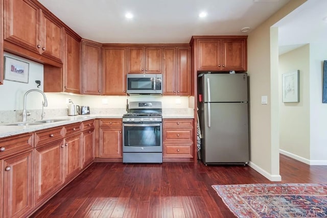 1129 La Casa, San Marcos, CA 92078 - kitchen featuring stainless steel appliances, dark wood-type flooring, brown cabinetry, light stone counters, and recessed lighting