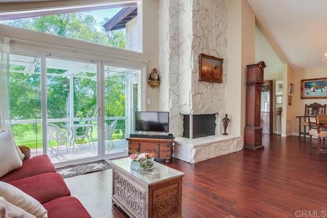 1129 La Casa, San Marcos, CA 92078 - living area with high vaulted ceiling, a stone fireplace, and wood finished floors