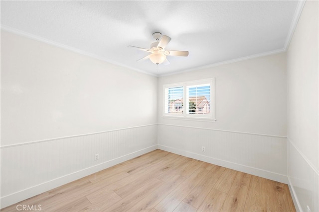 25311 Misty Rdg, Mission Viejo, CA 92692 - spare room featuring light wood-style flooring, crown molding, a ceiling fan, wainscoting, and baseboards