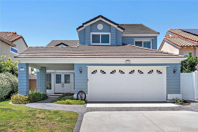 25311 Misty Rdg, Mission Viejo, CA 92692 - traditional home with a tiled roof, driveway, and french doors